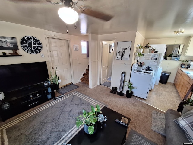 living room with light colored carpet and washer / clothes dryer