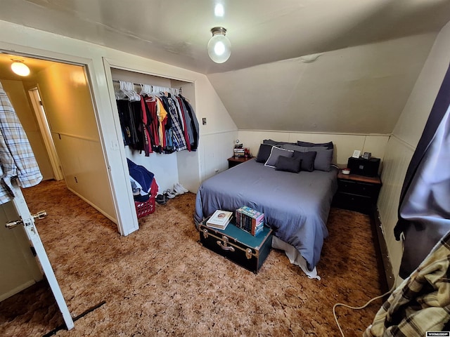 bedroom with carpet floors, a closet, and lofted ceiling