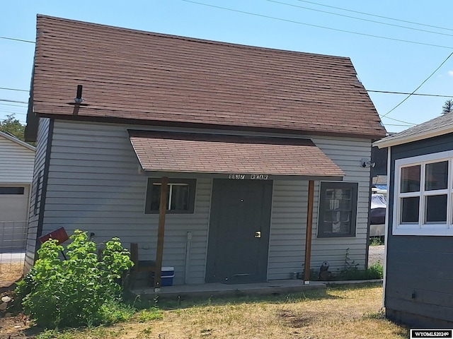 back of house with a lawn