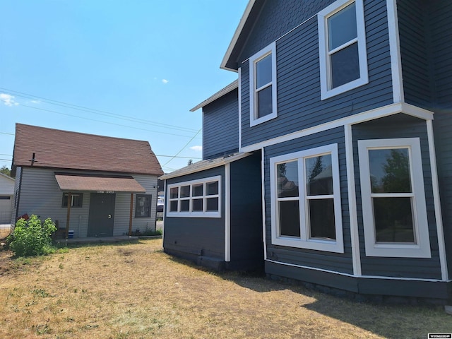 view of side of home featuring a yard