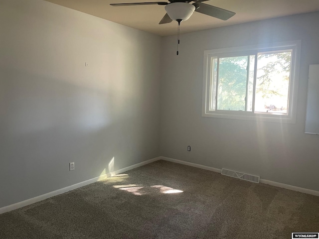 carpeted spare room featuring ceiling fan