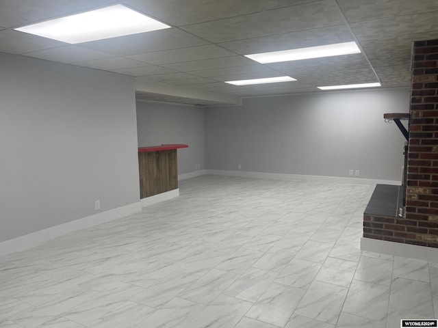 basement with a paneled ceiling