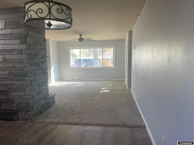 unfurnished living room with ceiling fan and hardwood / wood-style floors