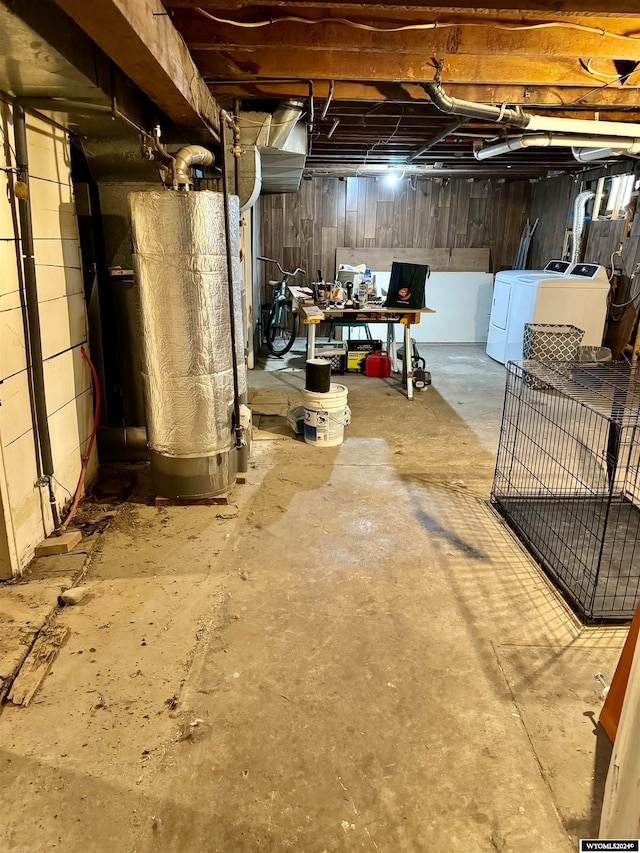 basement featuring washer and clothes dryer and gas water heater