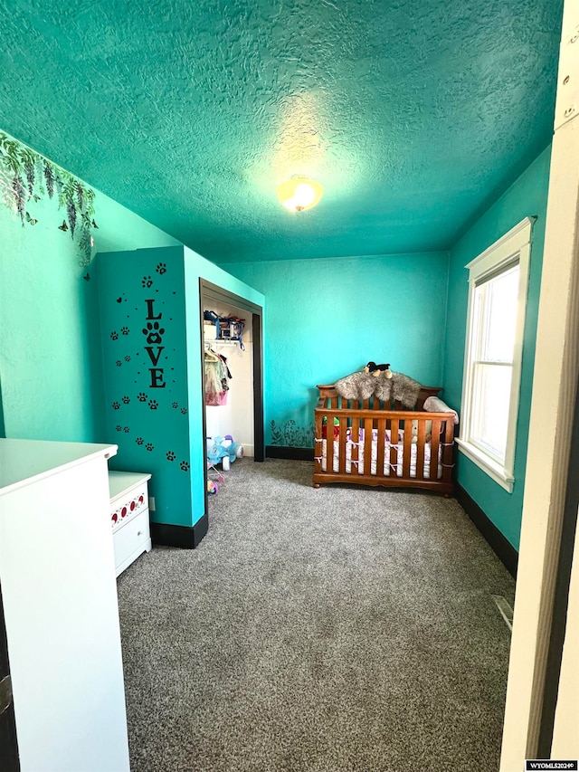 carpeted bedroom featuring a textured ceiling