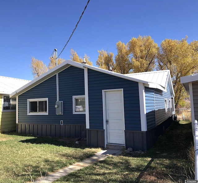 rear view of house with a yard