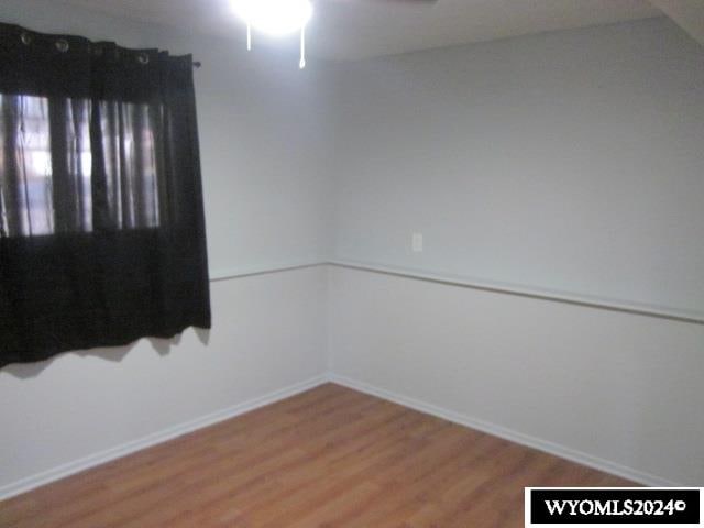 unfurnished room featuring ceiling fan and hardwood / wood-style floors