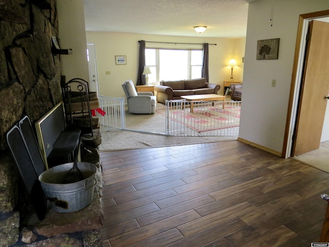 living room featuring a textured ceiling and hardwood / wood-style floors