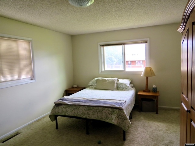 carpeted bedroom with a textured ceiling