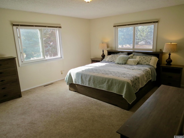 carpeted bedroom featuring a textured ceiling