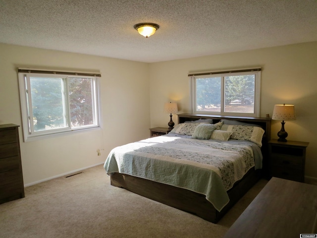 carpeted bedroom with a textured ceiling