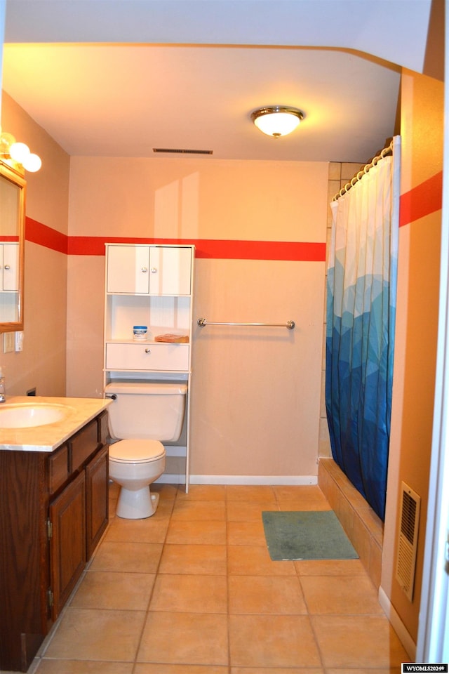 bathroom featuring a shower with shower curtain, vanity, toilet, and tile patterned floors