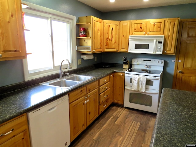 kitchen with dark wood-type flooring, white appliances, and sink