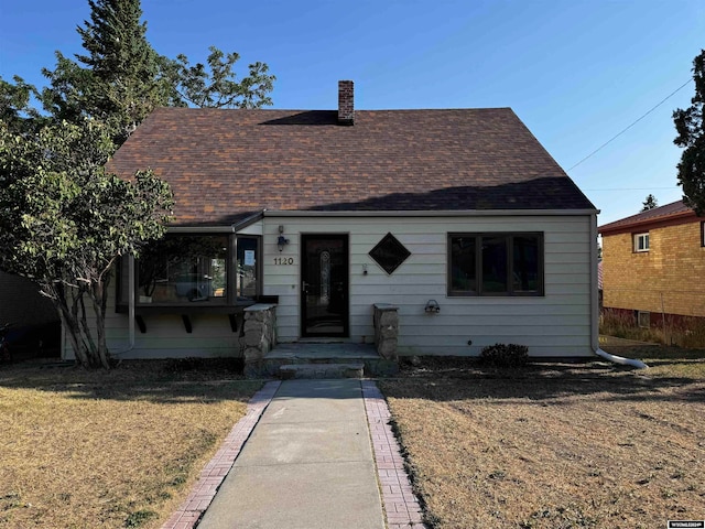 bungalow-style home featuring a front yard