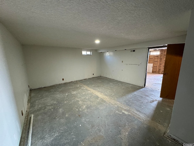 unfurnished room with a textured ceiling