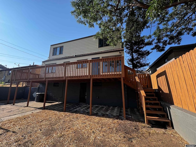 rear view of property with a wooden deck