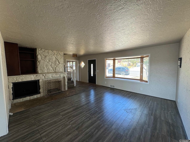 unfurnished living room featuring a fireplace and a textured ceiling