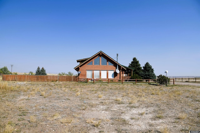 back of house with a rural view