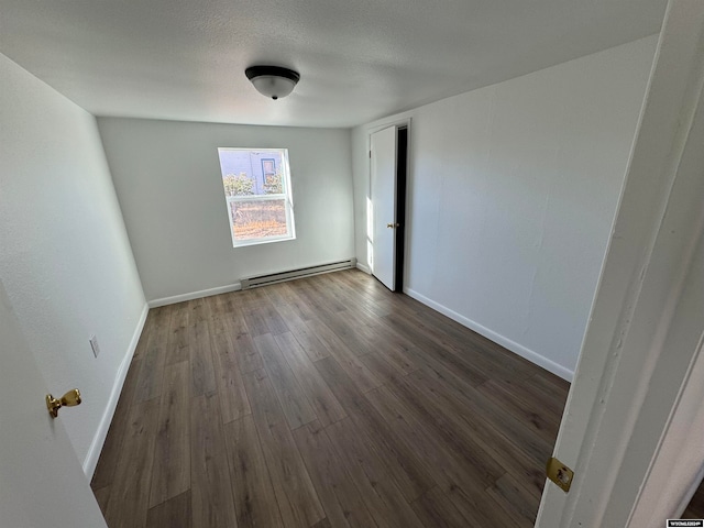 unfurnished room featuring dark hardwood / wood-style floors, a textured ceiling, and a baseboard radiator