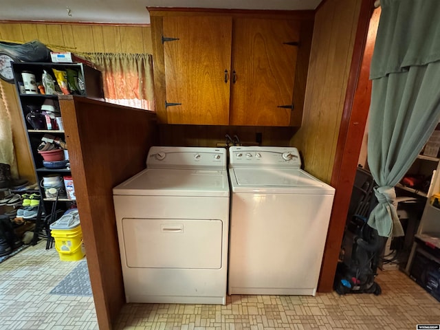 washroom with cabinets and washing machine and dryer