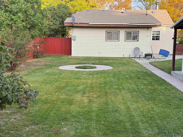 back of property with a lawn and a patio area