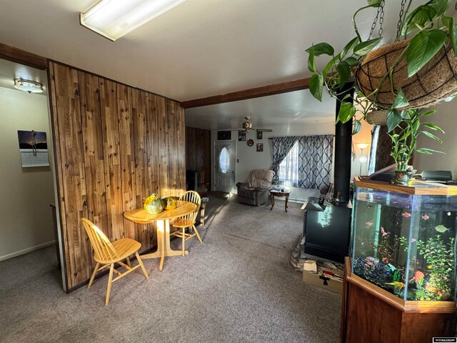 interior space featuring wood walls and carpet floors