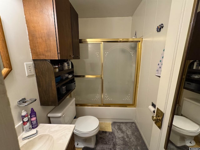 full bathroom featuring tile patterned floors, vanity, toilet, and shower / bath combination with glass door