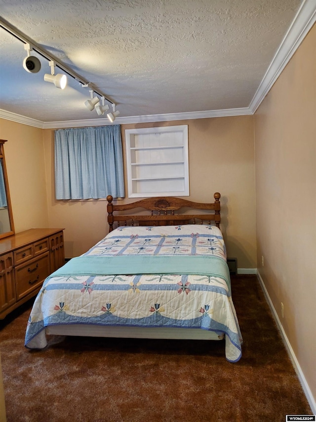 bedroom featuring dark carpet, a textured ceiling, crown molding, and track lighting