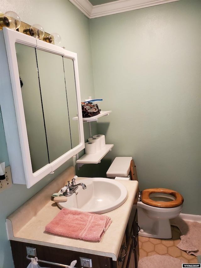 bathroom with crown molding, tile patterned floors, vanity, and toilet