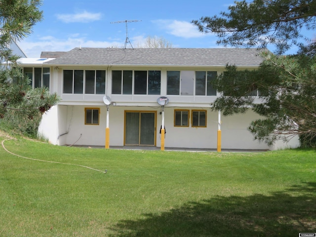 back of house featuring a yard