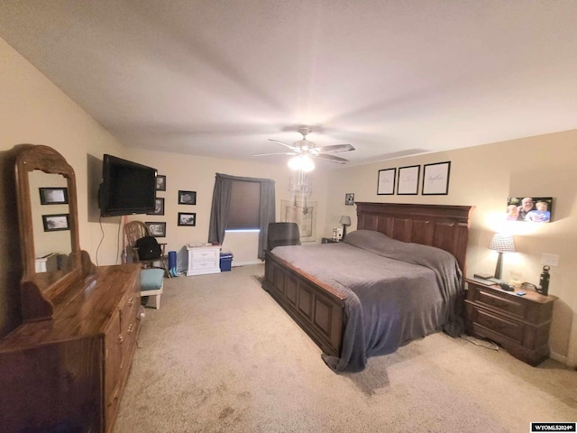 bedroom featuring light carpet and ceiling fan