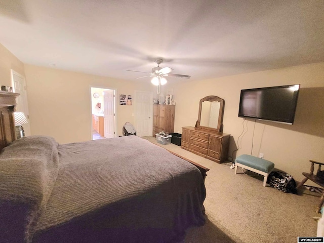 bedroom with ceiling fan, carpet, and connected bathroom