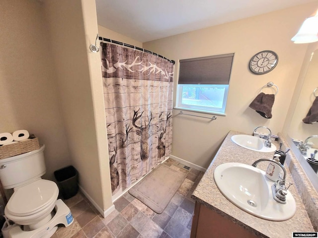 bathroom with toilet, vanity, and a shower with curtain