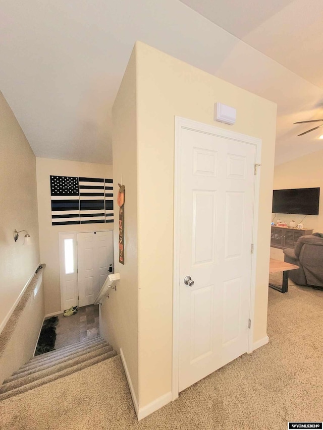 stairs with carpet floors and lofted ceiling