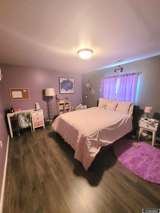 bedroom featuring dark hardwood / wood-style flooring