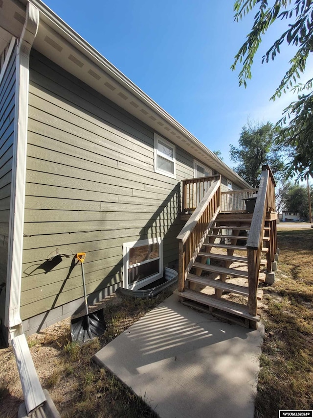 view of property exterior featuring a wooden deck