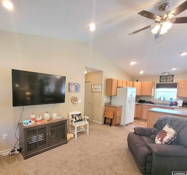 carpeted living room featuring ceiling fan and vaulted ceiling