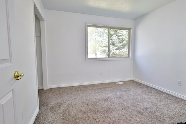 unfurnished bedroom with carpet and a textured ceiling