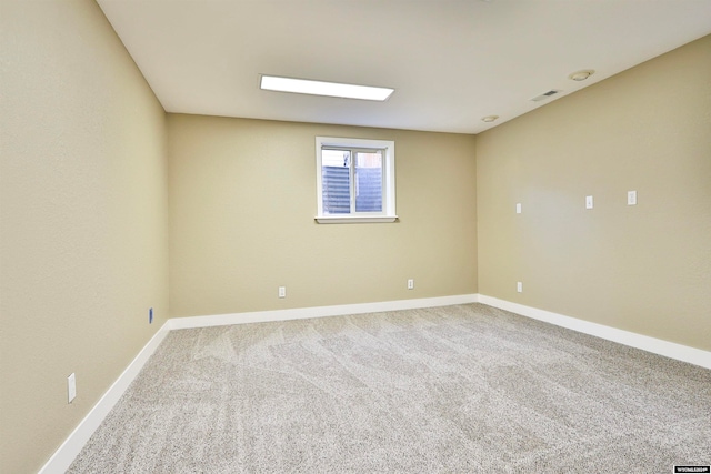 unfurnished room featuring light colored carpet