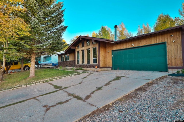 view of front facade with a garage and a front lawn