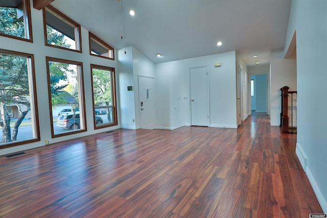 interior space featuring dark wood-type flooring, high vaulted ceiling, and beam ceiling