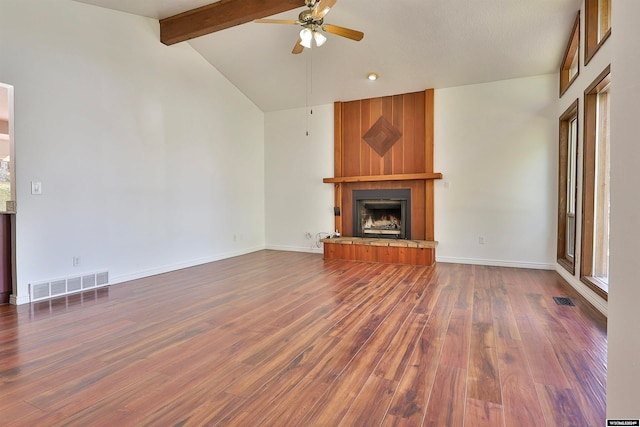 unfurnished living room featuring a fireplace, plenty of natural light, dark hardwood / wood-style flooring, and ceiling fan