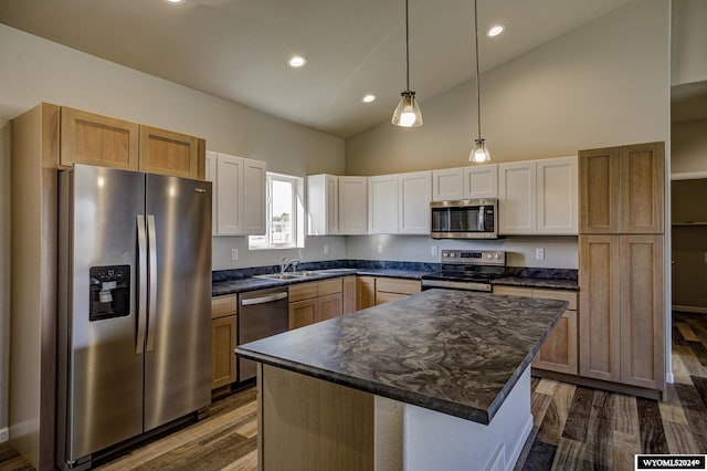 kitchen with a kitchen island, appliances with stainless steel finishes, pendant lighting, high vaulted ceiling, and white cabinets