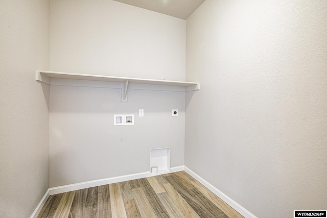 clothes washing area featuring hardwood / wood-style flooring, hookup for an electric dryer, and hookup for a washing machine