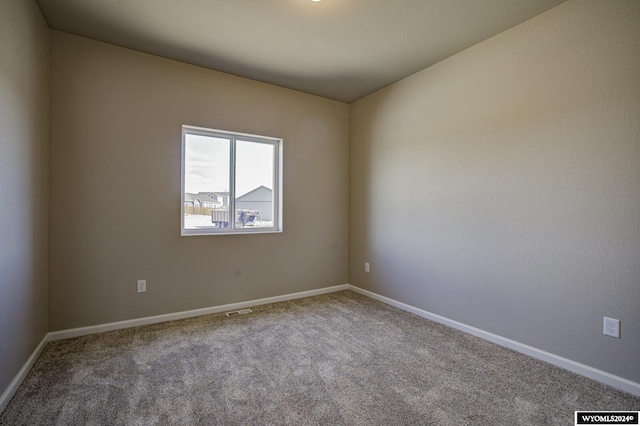 empty room with light colored carpet