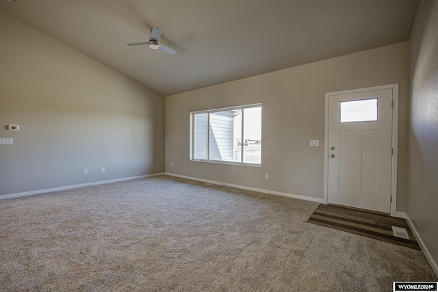 entryway with lofted ceiling, carpet floors, and ceiling fan