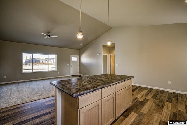 kitchen featuring dark hardwood / wood-style floors, lofted ceiling, hanging light fixtures, a center island, and light brown cabinets