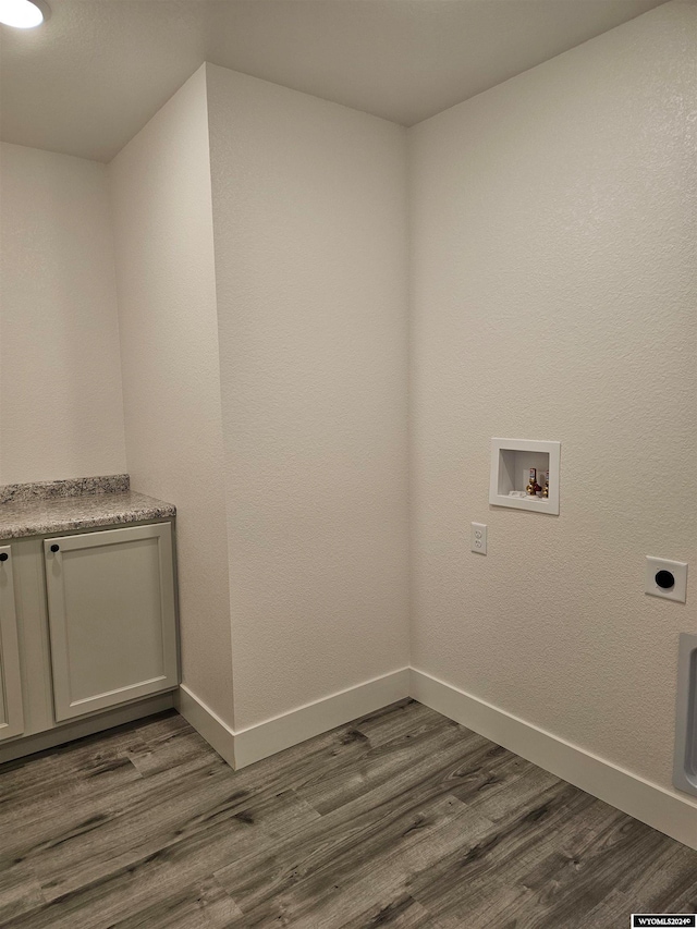 clothes washing area featuring hookup for an electric dryer, dark hardwood / wood-style floors, hookup for a washing machine, and cabinets