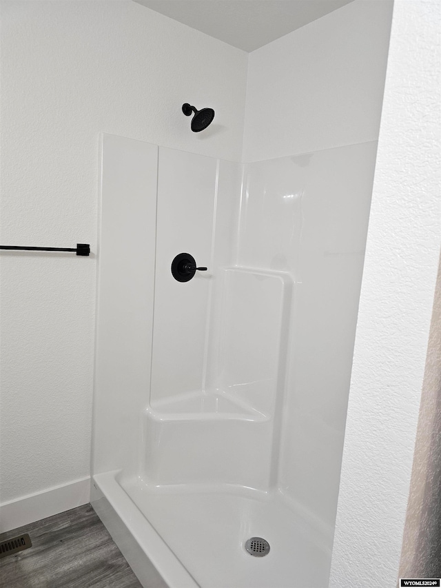 bathroom with a shower and hardwood / wood-style flooring