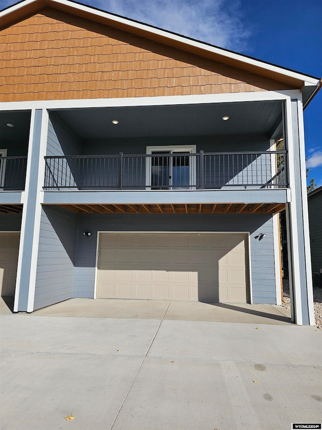 view of front facade featuring a balcony and a garage